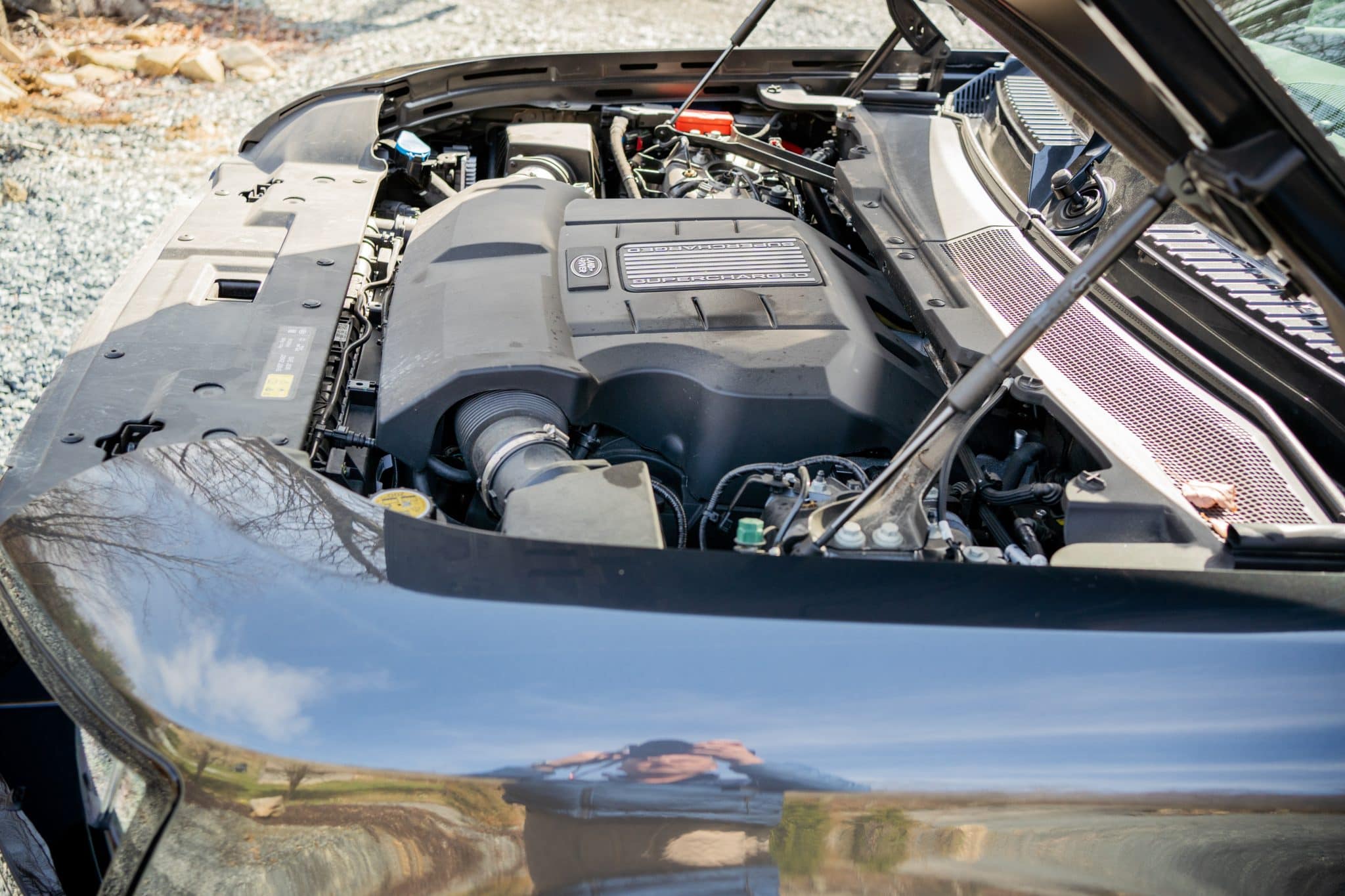 Open engine bay of a supercharged Land Rover Defender 90, photographed for a pre-purchase inspection