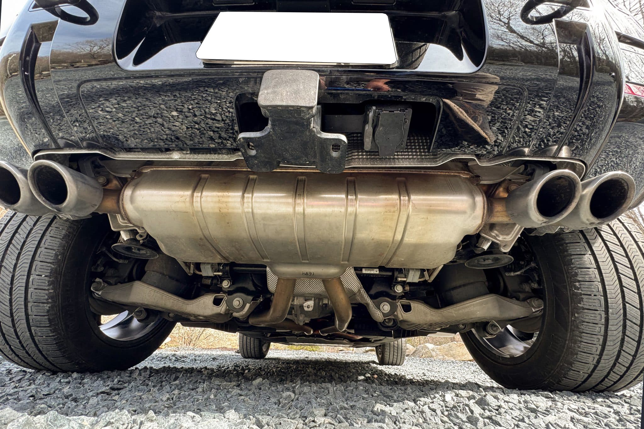 Underbody of a Land Rover Defender 90 photographed from behind, showing the exhaust, silencer, rear suspension and subframe