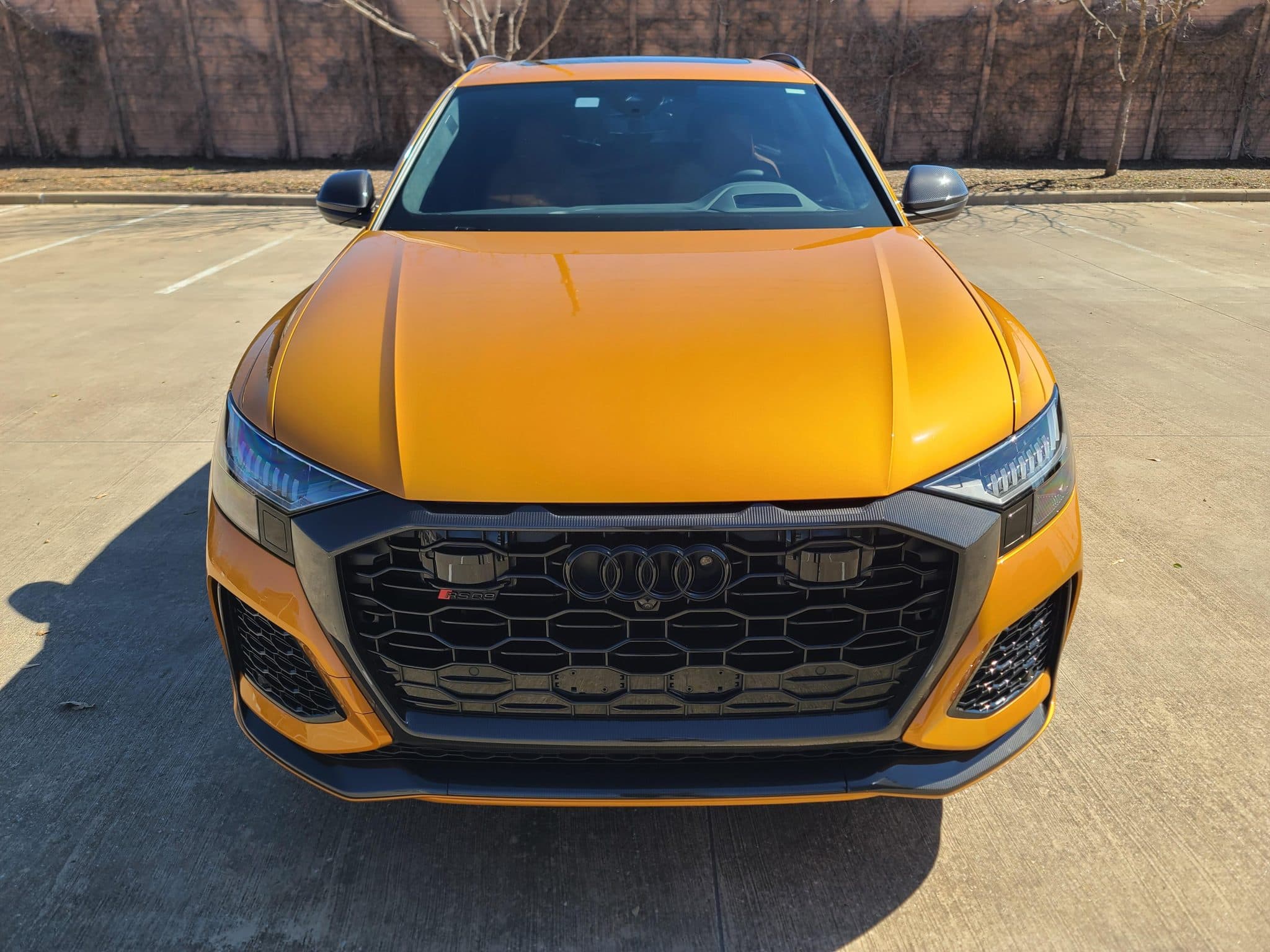 Orange Audi RS Q8 photographed head-on for a Carviondealer listing